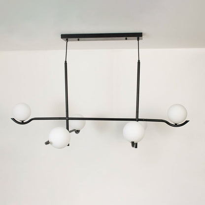 Black metal chandelier with white globes shown on a bright white background with lights turned off for a minimal look.