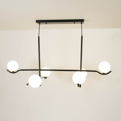 Black metal chandelier with frosted glass globe shades creating elegant ambient lighting for modern interior spaces.