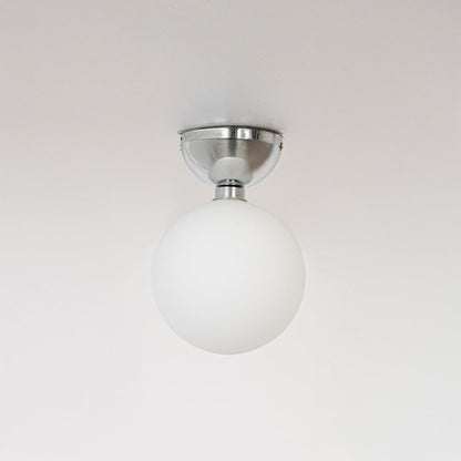 Ceiling light with polished chrome base and frosted glass globe shade shown off on plain white background.