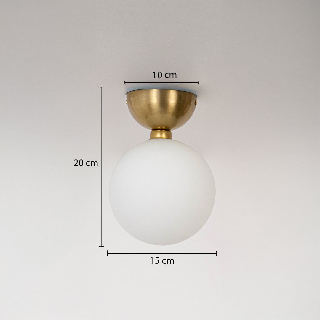 Ceiling light with gold base and frosted glass globe shown with size dimensions 20 cm height 15 cm width and 10 cm base.