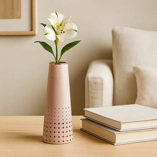 Pink ceramic vase with gold detailing placed on a white shelf adding a soft modern accent ideal for living room and bedroom decor.