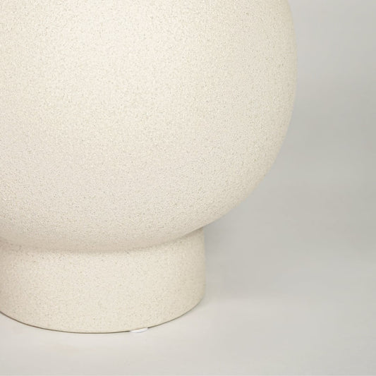 Closeup of matte white ceramic round vase with minimalist design ideal for elegant home decor shelf or side table styling.