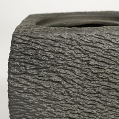Close up view dark grey textured ceramic planter showing rough sculpted surface matte finish decorative ceramic accent.