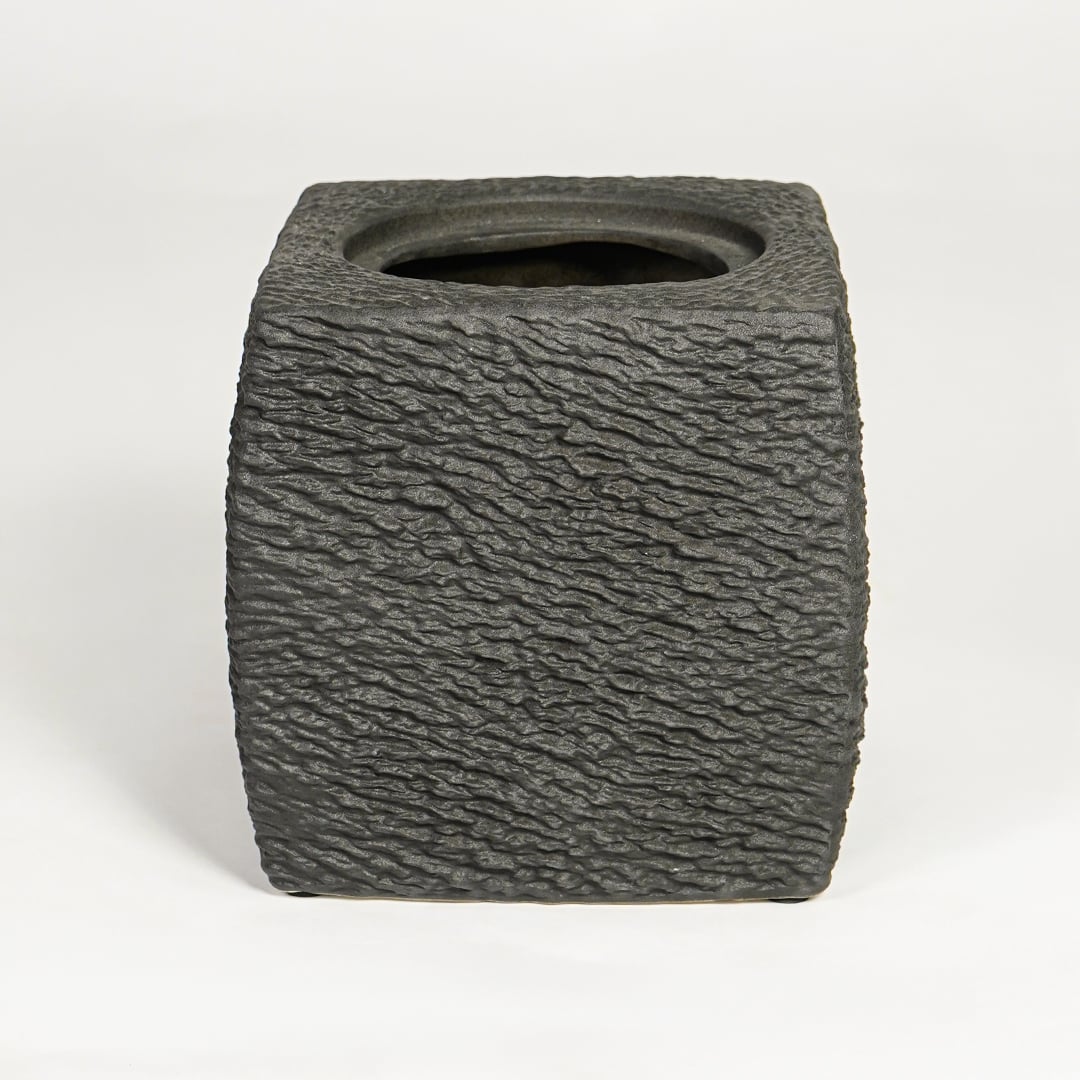 Dark grey decorative ceramic planter on white background modern home decor accent piece for table floor console styling.