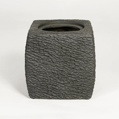 Dark grey decorative ceramic planter on white background modern home decor accent piece for table floor console styling.