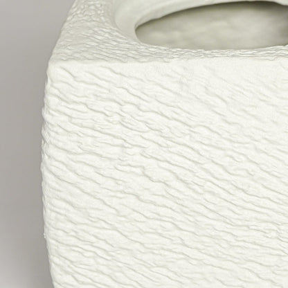 Close up view white textured ceramic planter showing rough sculpted surface matte finish decorative ceramic accent.