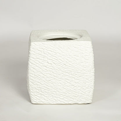 White decorative textured ceramic planter on white background modern home decor accent piece for table floor console styling.