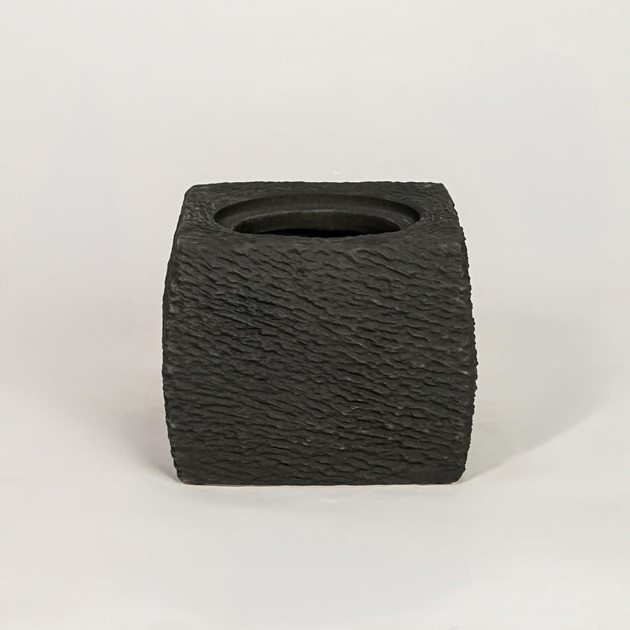 Black ceramic planter with textured matte finish for modern tabletop shelf and console decor placement.