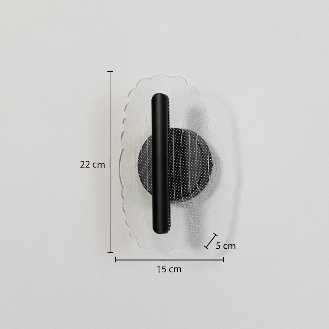 Black metal wall light with clear acrylic decorative shade shown with 22 cm height and 15 cm width for accurate sizing.