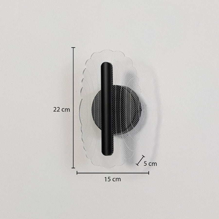Black metal wall light with clear acrylic decorative shade shown with 22 cm height and 15 cm width for accurate sizing.