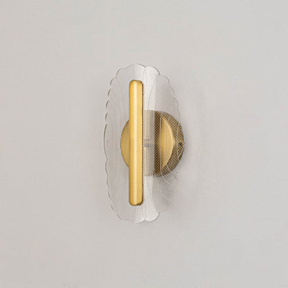 Gold metal wall light with clear acrylic patterned shade shown on a white background with lights off.