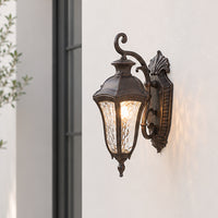 Vintage bronze metal outdoor wall lantern for porch entrance balcony and exterior walls with warm ambient lighting.