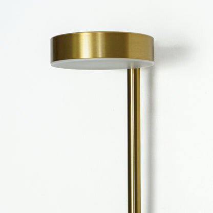 Closeup of gold metal wall light with round top plate showcasing smooth finish and premium detailing for interior decor styling.