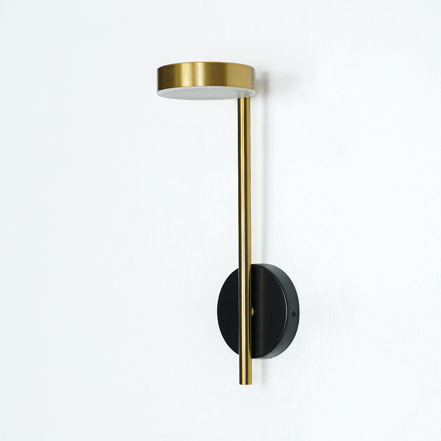 Gold metal wall light with vertical rod and circular top design ideal for modern bedroom or hallway wall decor on clean background.