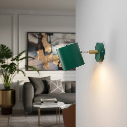 Modern green metal spotlight wall light creating stylish ambient lighting in contemporary living room decor.
