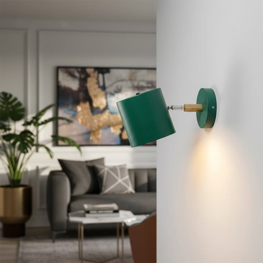 Modern green metal spotlight wall light creating stylish ambient lighting in contemporary living room decor.