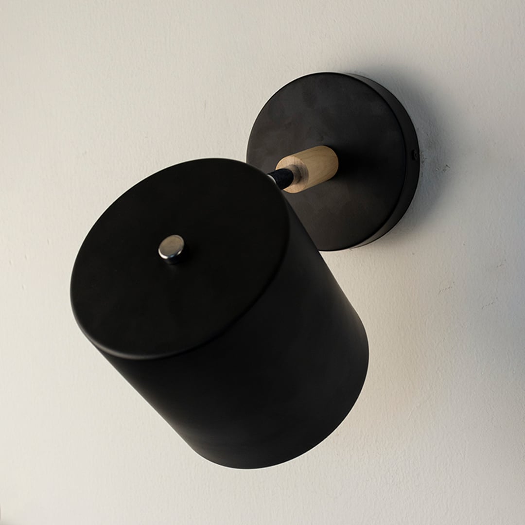 Modern black metal spotlight wall light with matte finish for elegant bedroom and hallway decor.
