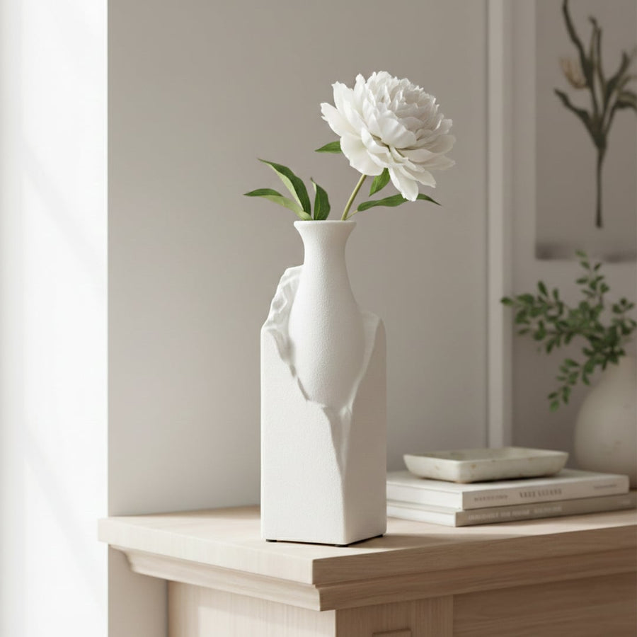 Tall white ceramic vase with sculptural crack texture styled in modern interior minimal decorative floor or console vase for living room bedroom or office decor.