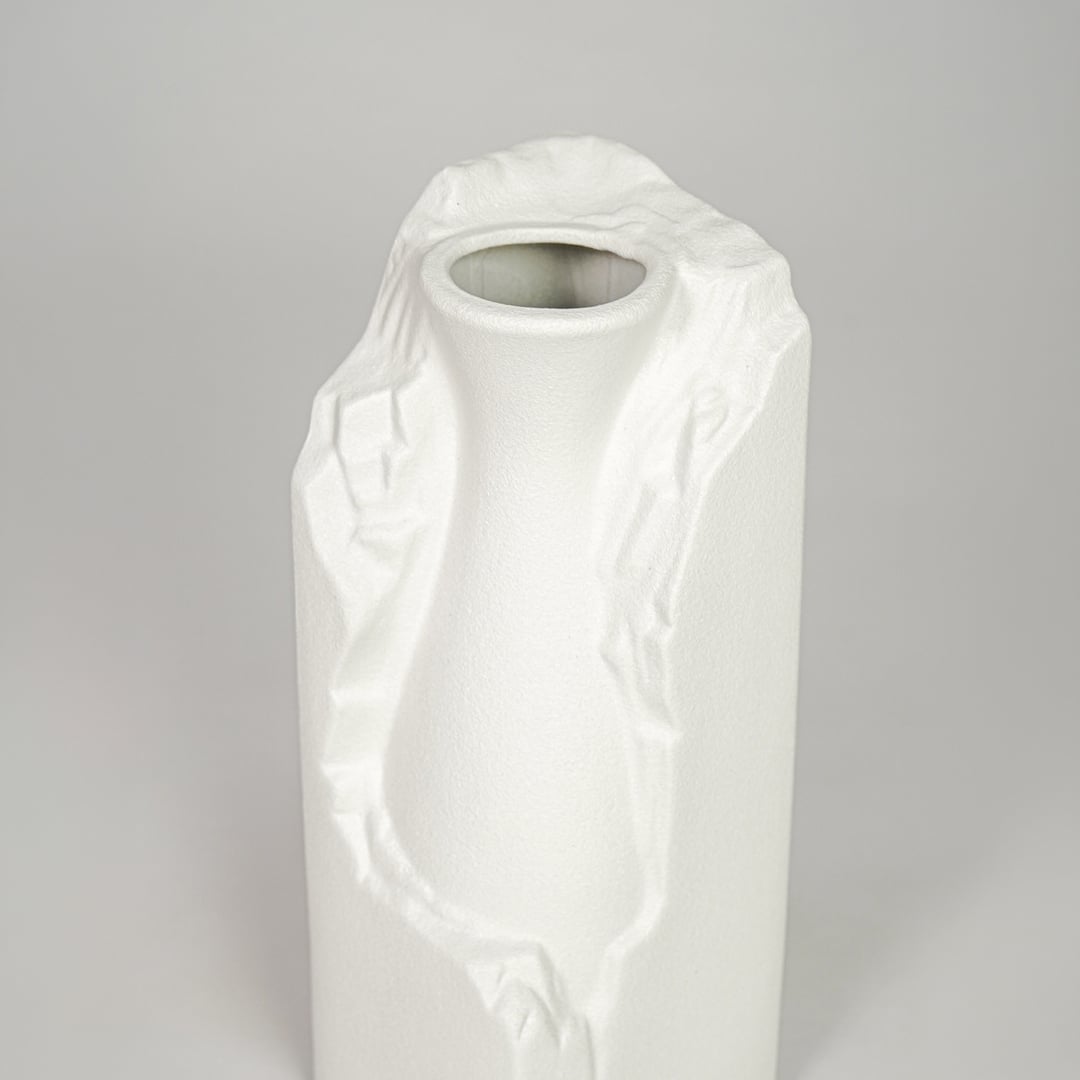 White ceramic flower vase closeup with textured finish modern decorative vase for shelf console table decor styling.