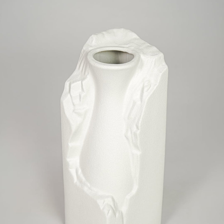 White ceramic flower vase closeup with textured finish modern decorative vase for shelf console table decor styling.