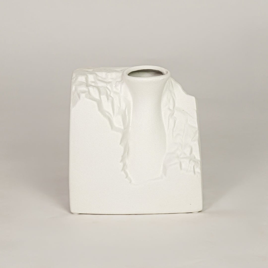 White ceramic decorative vase with sculpted artistic texture for modern tabletop shelf and console decor placement.
