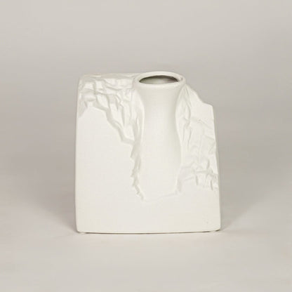 White ceramic decorative vase with sculpted artistic texture for modern tabletop shelf and console decor placement.