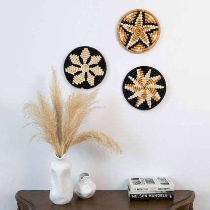 Handwoven seagrass wall basket decor set in natural beige and black creating elegant boho wall decor for home interiors.