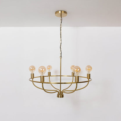 Contemporary brass gold circular cage chandelier with chain and Edison bulb sockets turned off displayed on white background.