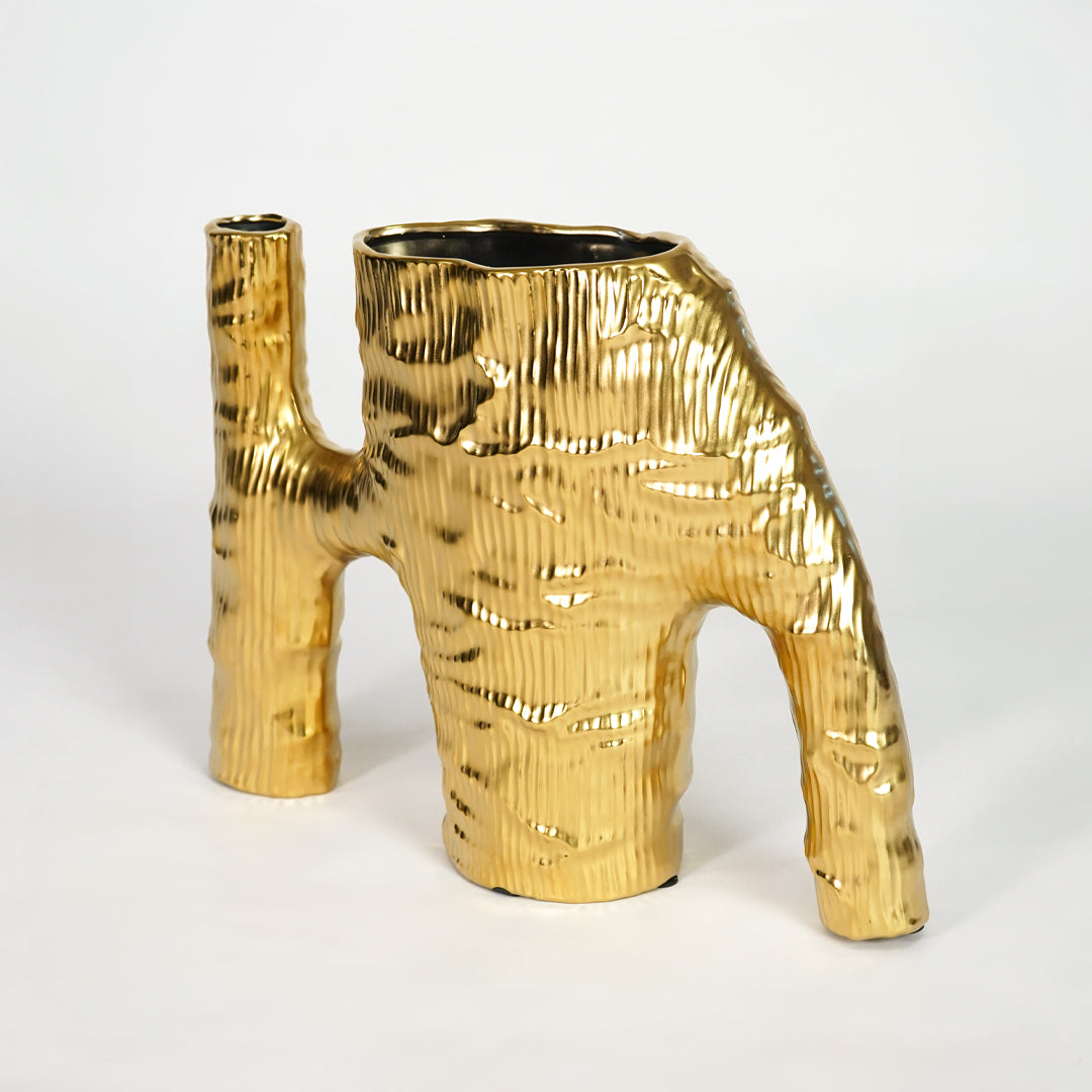 Metallic gold sculptural ceramic vase for elegant shelf placement and contemporary indoor home decor styling accent piece.