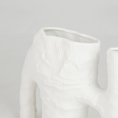 Closeup image of white ceramic abstract vase for modern tabletop decor styling with artistic matte textured finish.