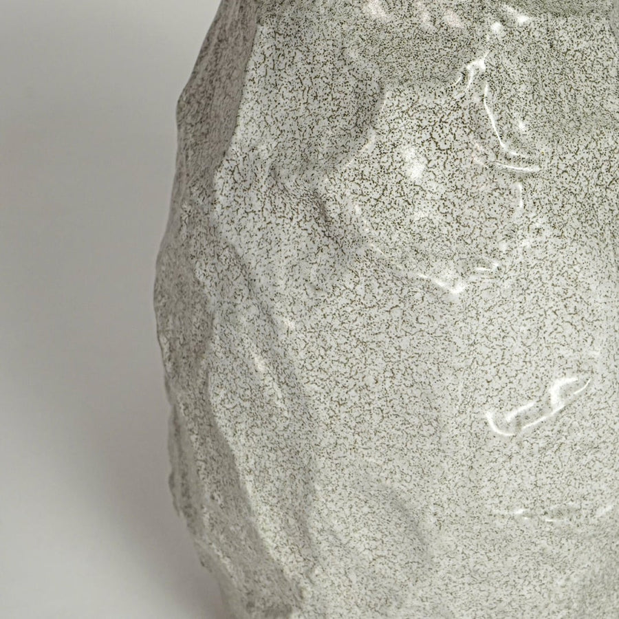 White decorative textured ceramic vase on white background modern home decor accent piece for table shelf console styling.