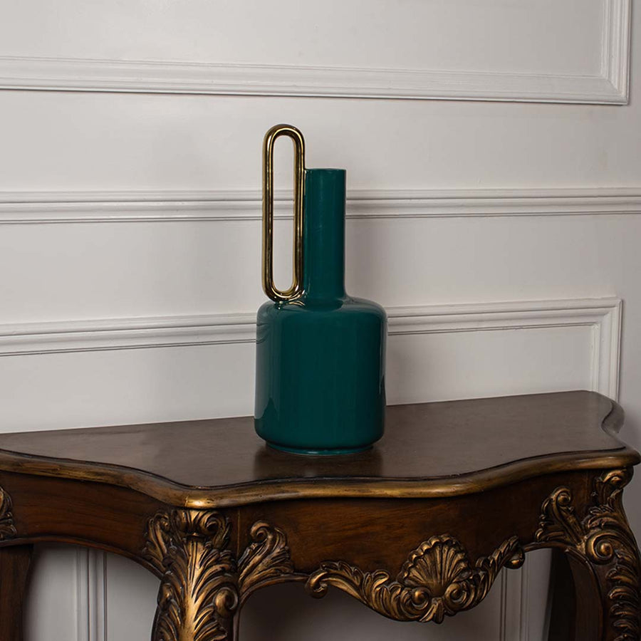 Teal ceramic vase with glossy finish and gold handle displayed on a clean white background ideal for minimal modern interior styling.