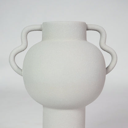 Closeup image of white ceramic handle vase for modern living room tabletop decor with smooth matte finish styling.