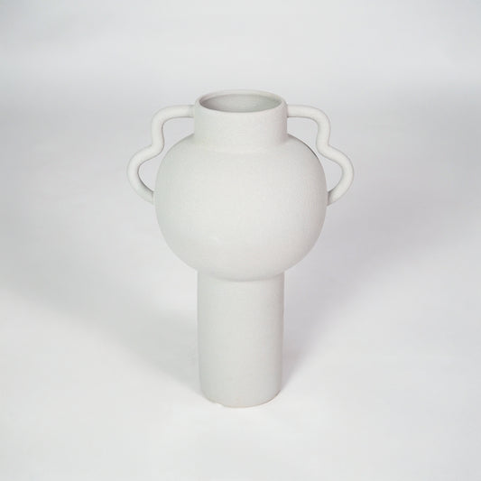 White ceramic vase with side handles for modern shelf placement and elegant indoor home decor styling accent.