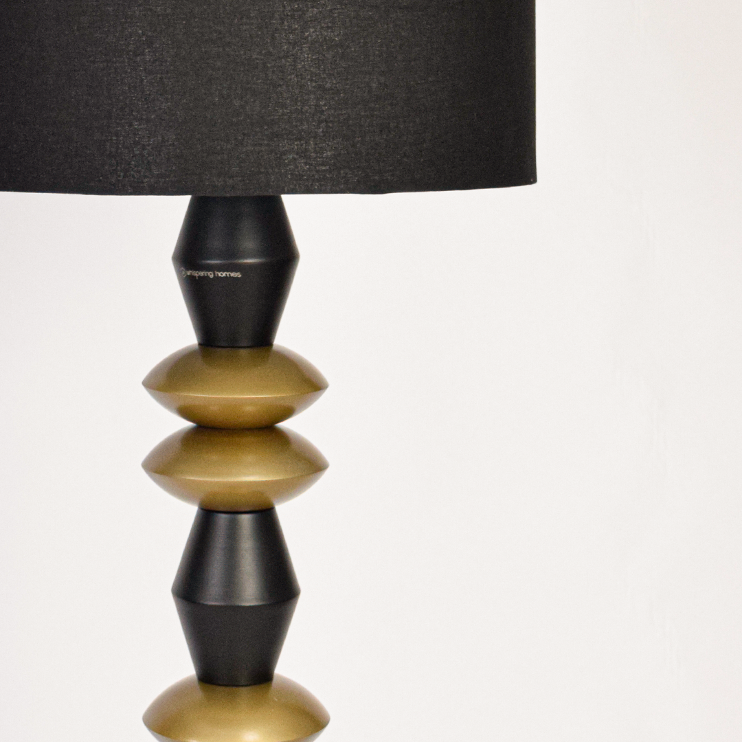Floor lamp shade closeup highlighting black fabric texture with clean cylindrical form creating refined contrast and premium lighting craftsmanship.