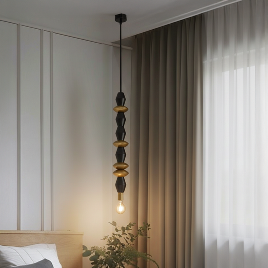 Black and gold metal pendant light with decorative beads adding warmth to modern bedroom interiors.