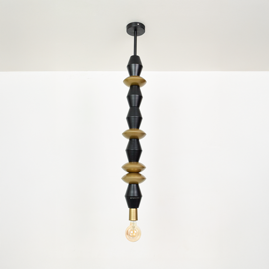Black and gold metal pendant light with sculptural bead accents for elegant home decor spaces.