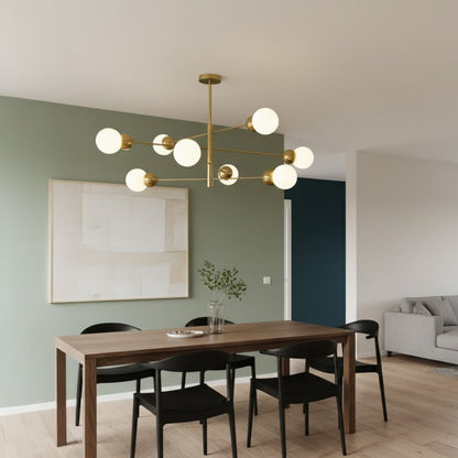 Modern chandelier with metal arms and glass globes hanging above dining table adding balanced lighting and contemporary interior elegance.