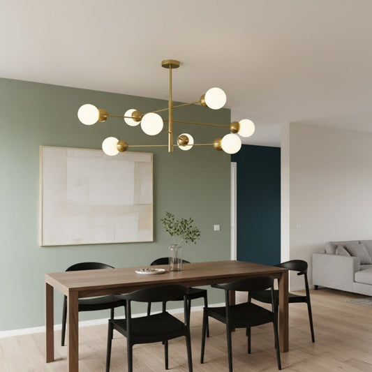 Modern chandelier with metal arms and glass globes hanging above dining table adding balanced lighting and contemporary interior elegance.