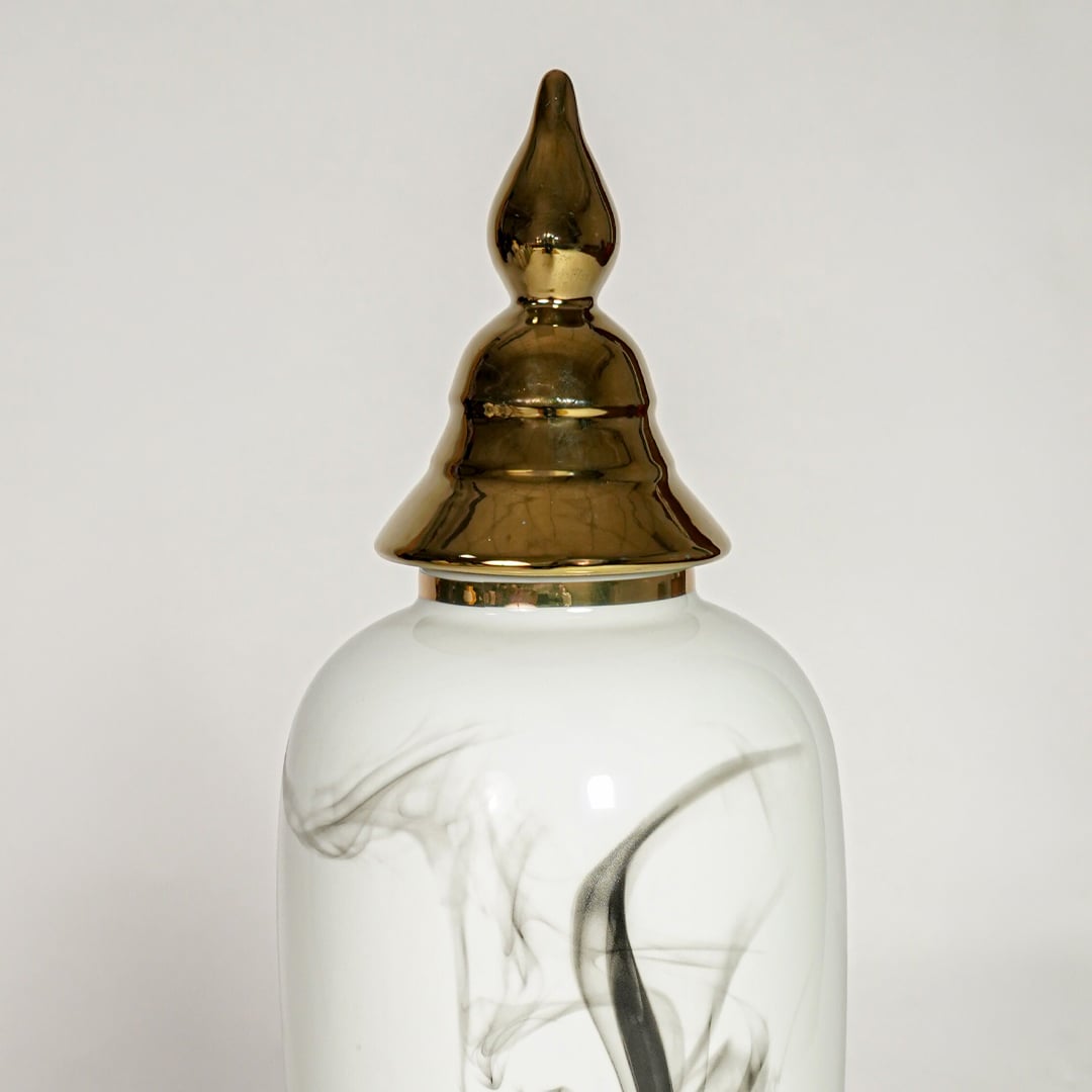 White ceramic decorative vase with elegant black marble swirl pattern and gold lid perfect for luxury interior decor styling.