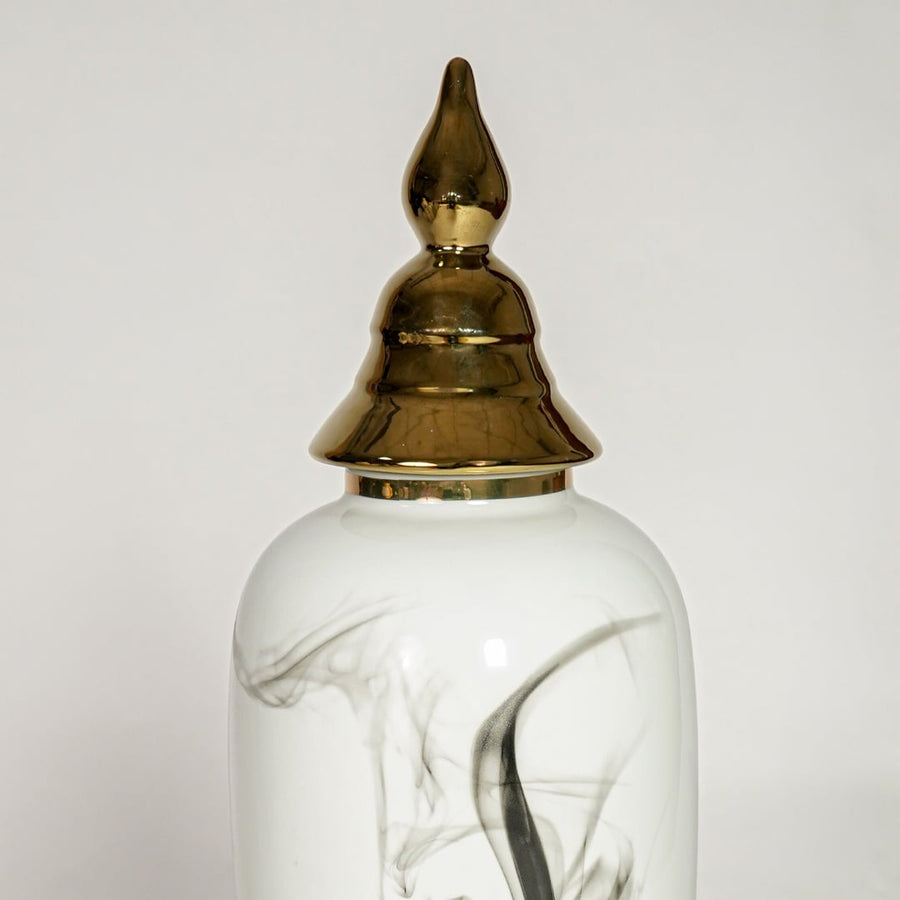 White ceramic decorative vase with elegant black marble swirl pattern and gold lid perfect for luxury interior decor styling.