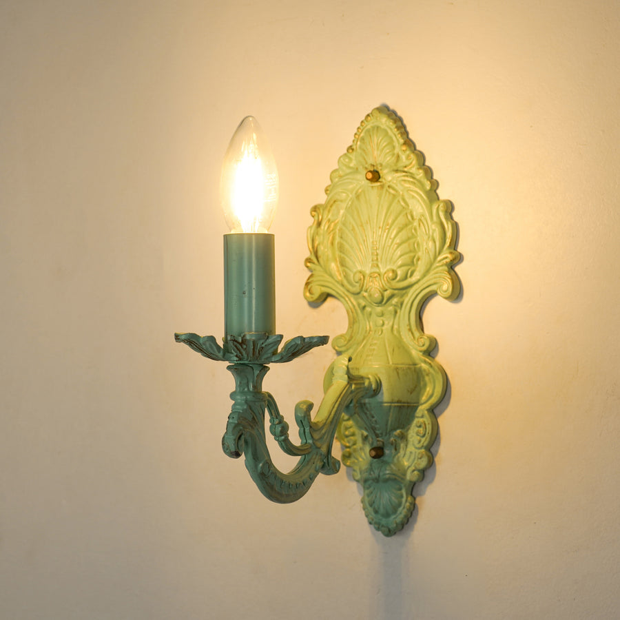 White background image of illuminated aluminium era small light wall sconce for elegant living room decor styling setup.