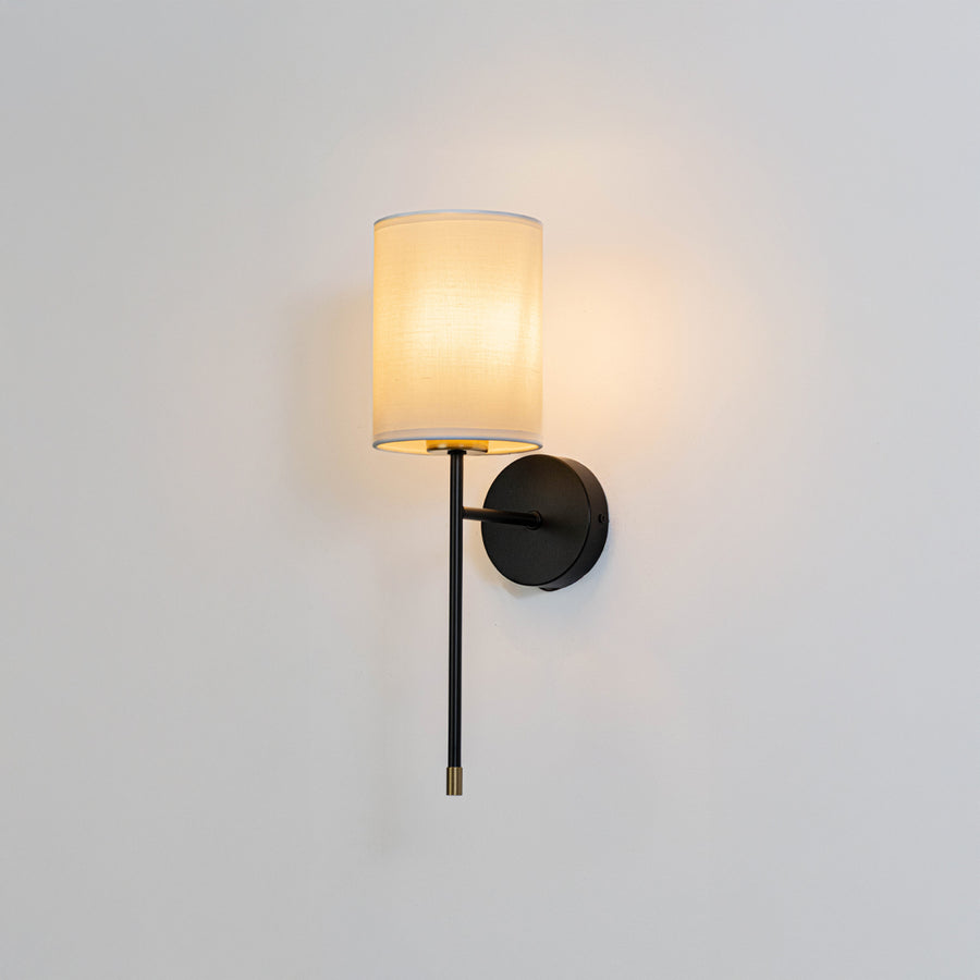 Black metal wall light with fabric shade on white background for elegant modern bedroom wall decor.