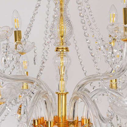 Closeup of chandelier showing gold detailing with crystal glass arms and hanging droplets for luxury design.
