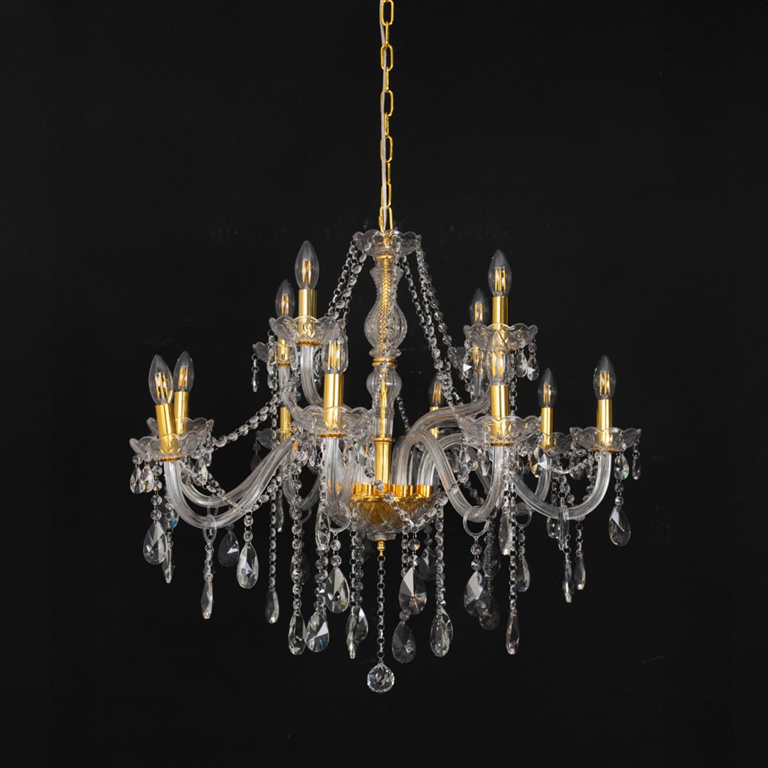 Chandelier with crystal glass and gold finish displayed off against black background for classic home style.