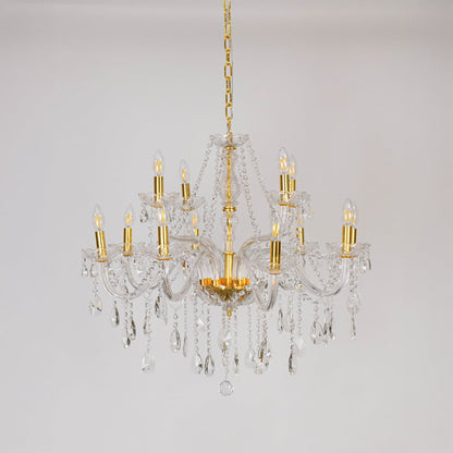 Crystal chandelier with gold detailing displayed off on white background highlighting luxury light fixture.