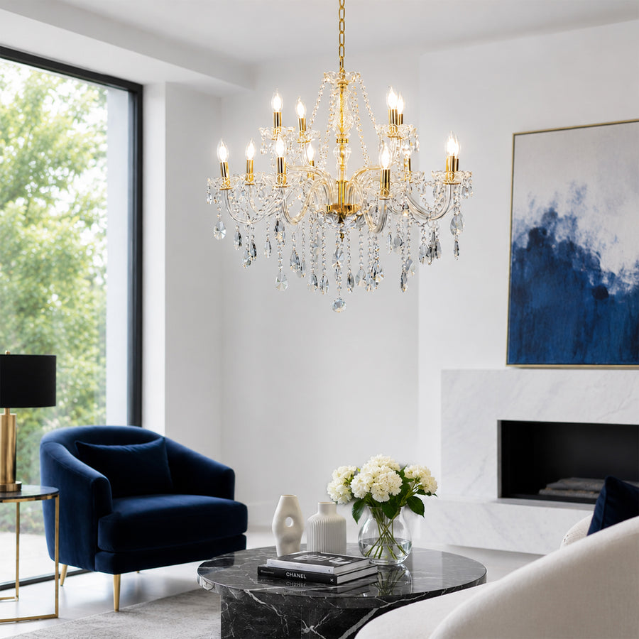 Crystal chandelier with gold accents glowing warmly above sofa in living room for luxury interior decor.