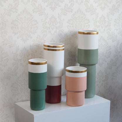 Green ceramic vase with white band and gold rim styled with coordinated decor pieces perfect for elegant contemporary interior styling.