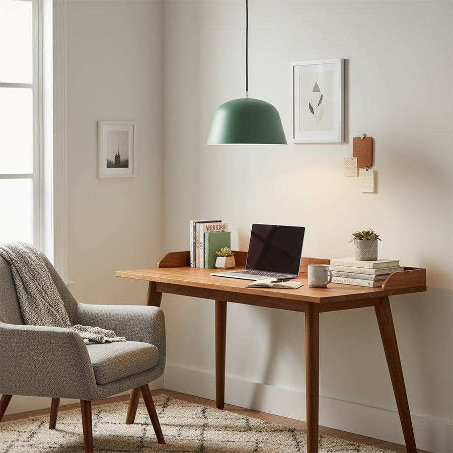 Matte green dome pendant light hanging above wooden study desk adding a calm modern touch to cozy home workspace.