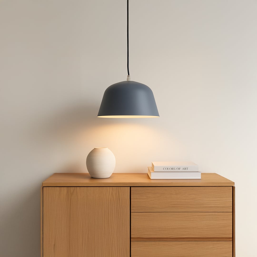 Matte blue dome pendant light illuminating a modern wooden sideboard creating a calm and sophisticated interior setting.